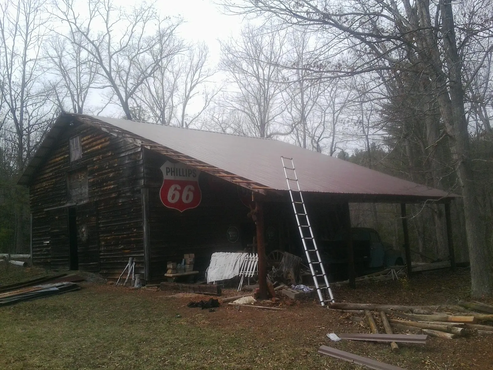 New metal roof on an open sided timber barn with a vintage sign in Granville